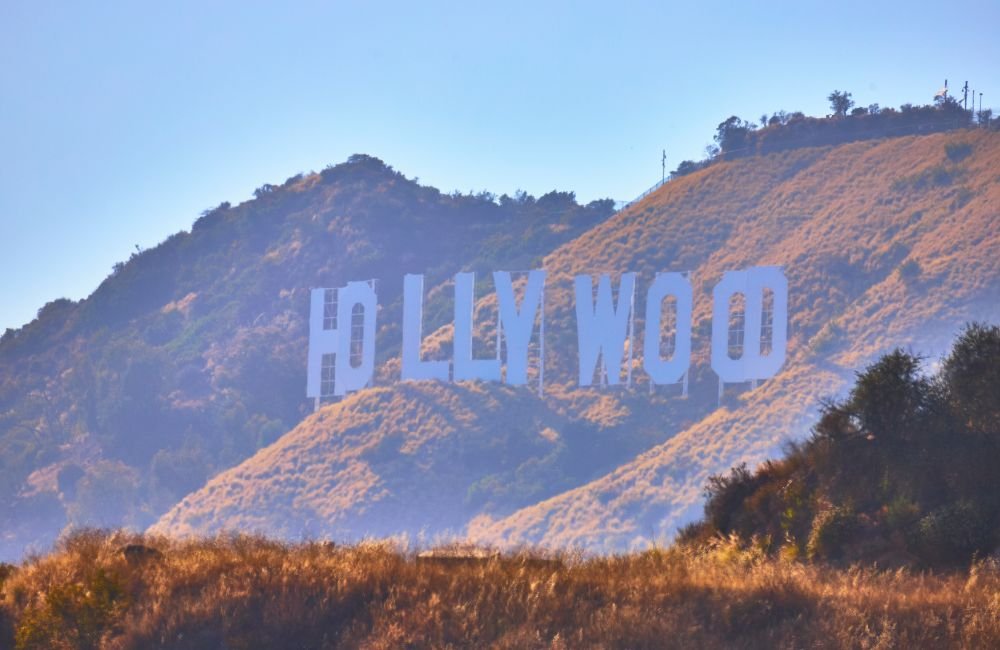 Runyon Canyon hiking trail overlooking the Hollywood Hills, Hollywood Sign and Los Angeles skyline at sunset.