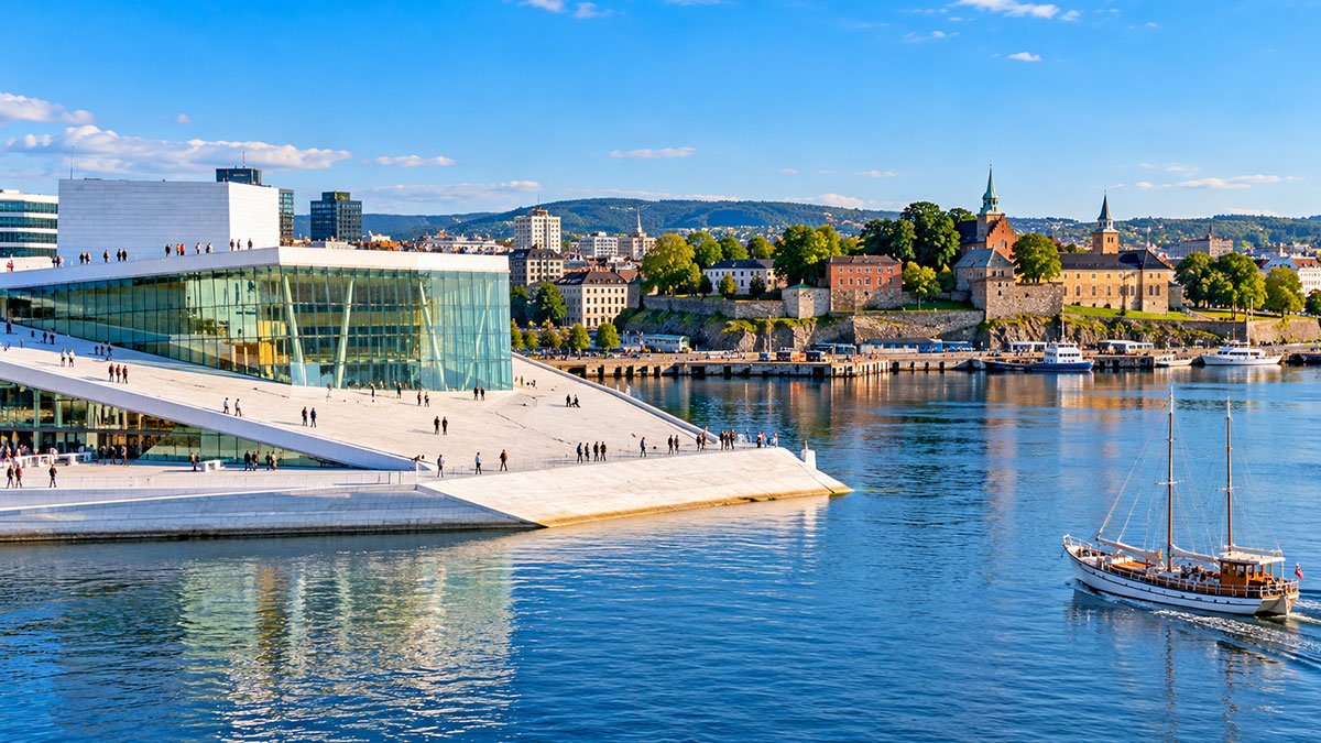 Oslo Opera House and Akershus Fortress across the waterfront in Oslo, Norway.